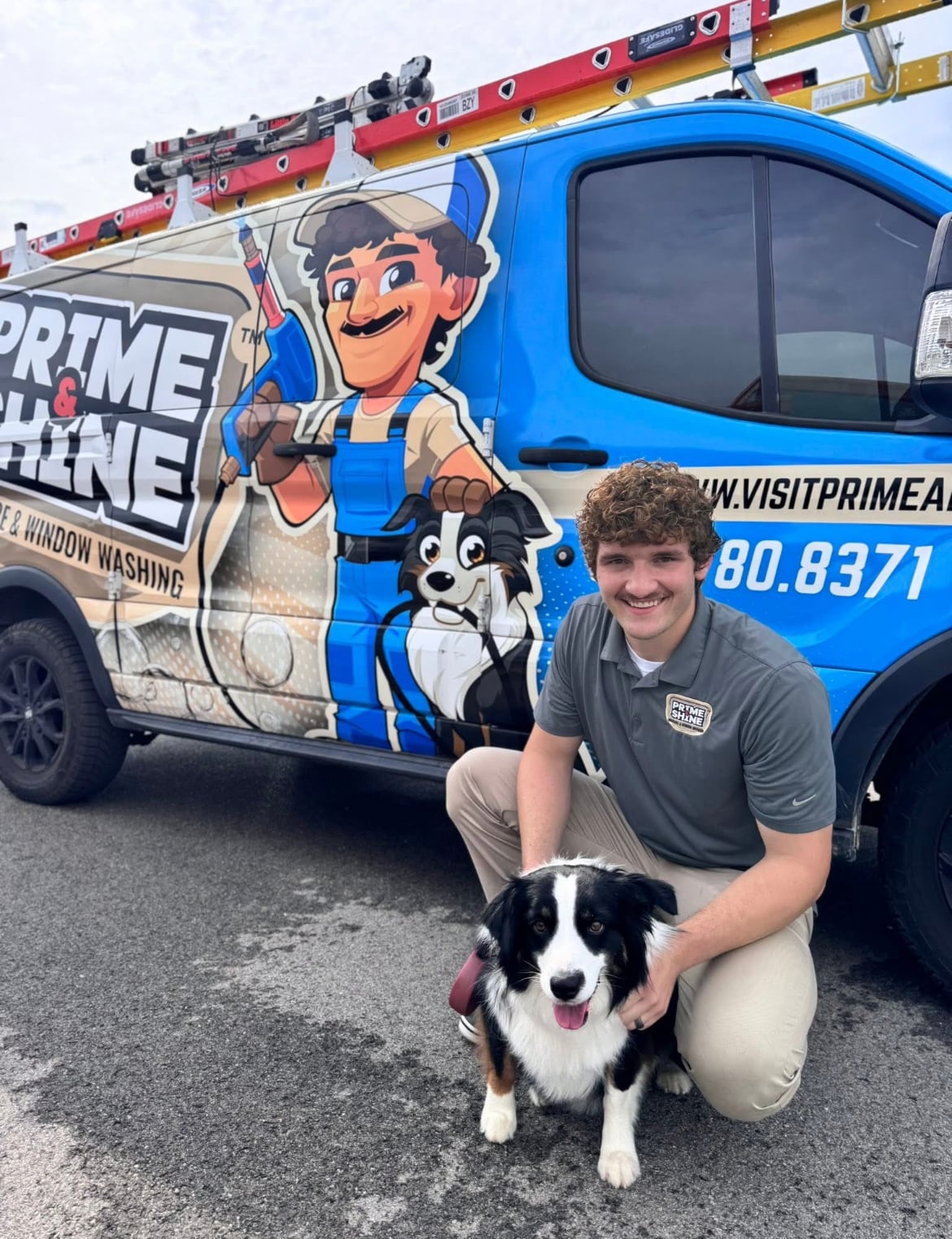 Micheal Norris kneeling with dog beside branded company van